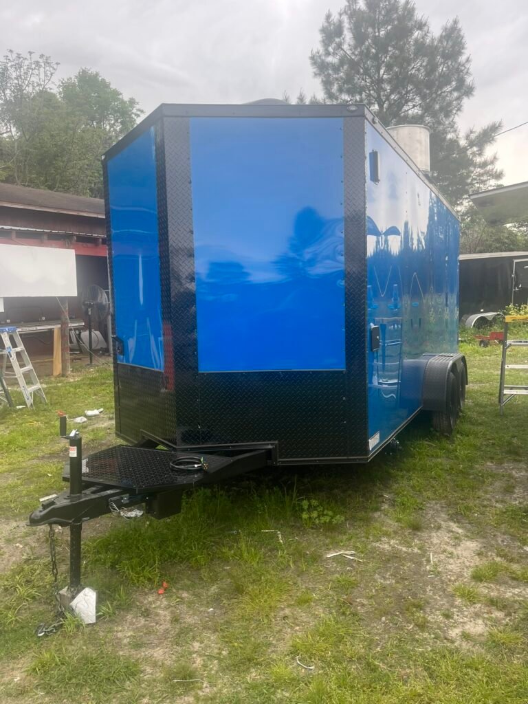 a blue trailer on grass