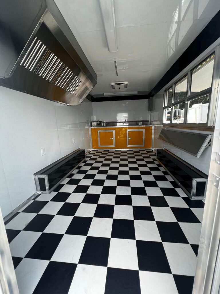 a black and white checkered floor with a yellow counter and cabinets