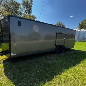 a black trailer on grass