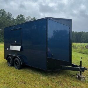 a black trailer in a field