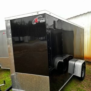 a black trailer with a white roof