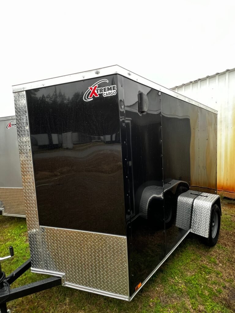 a black trailer with a white roof