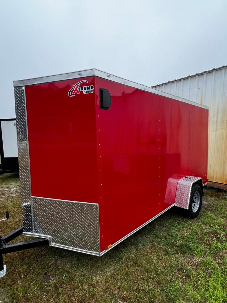 a red trailer with a white wall