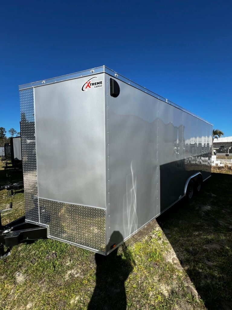 a silver trailer on grass