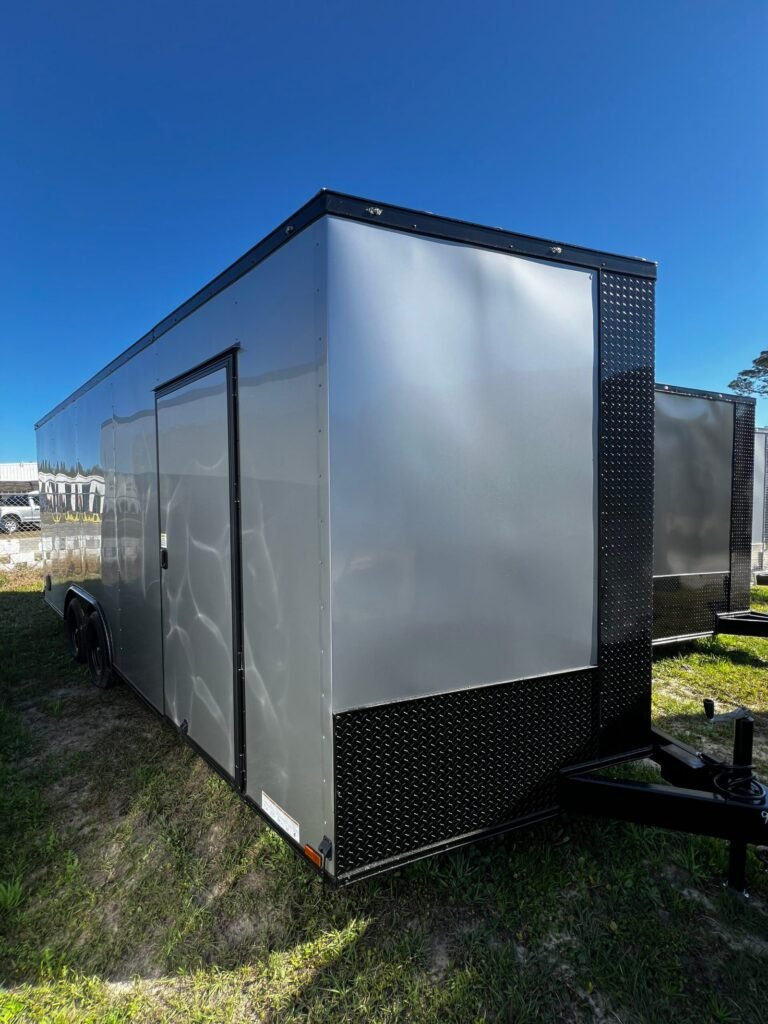 a trailer on grass with a blue sky