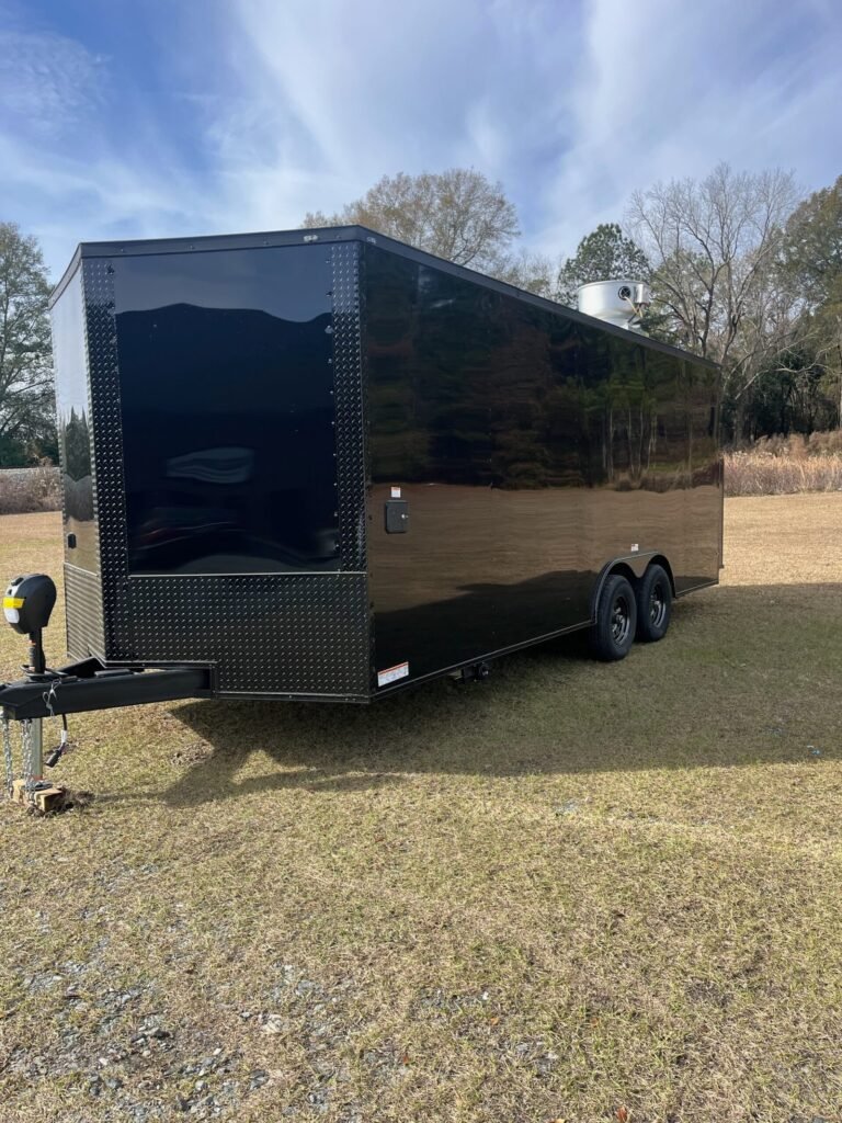 a black trailer on grass