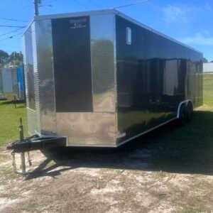 a black trailer on grass