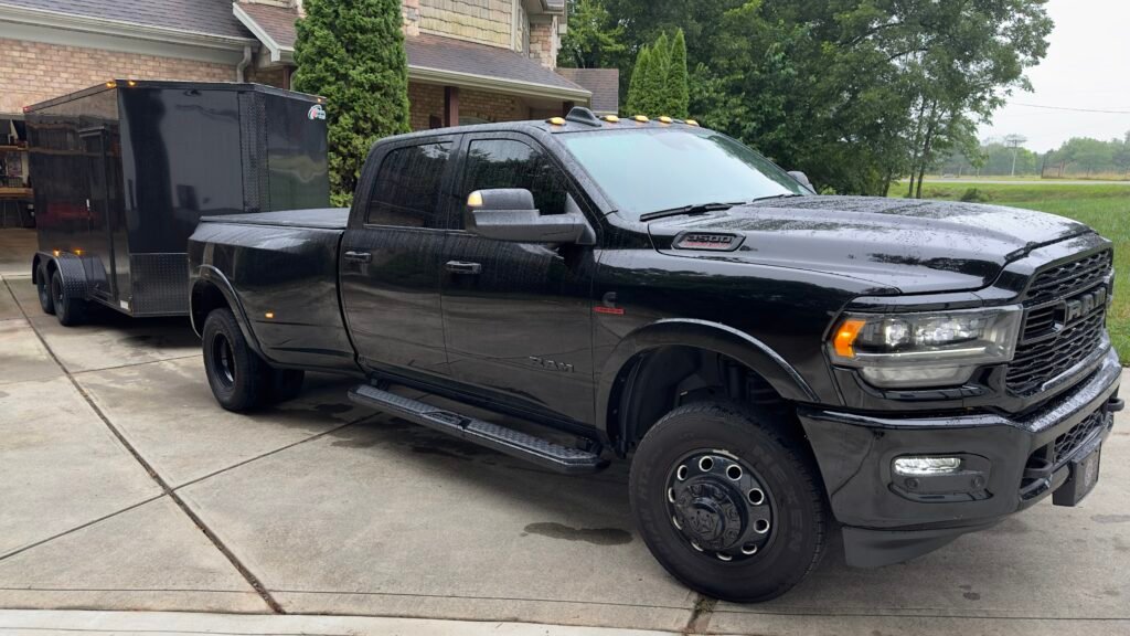 a black truck parked in a driveway